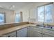 Kitchen with white cabinets, tile floors, and dishwasher at 6920 E 4Th St # 105, Scottsdale, AZ 85251