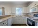 Kitchen with white cabinets, tile floors, and appliances at 6920 E 4Th St # 105, Scottsdale, AZ 85251