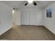 Large bedroom with double door closet and neutral carpeting at 7320 N 46Th Cir, Glendale, AZ 85301