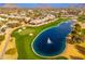 Aerial view showcasing a pond and golf course at 8641 E Clubhouse Way, Scottsdale, AZ 85255