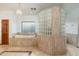 Large bathroom with a soaking tub and a glass block shower at 8641 E Clubhouse Way, Scottsdale, AZ 85255