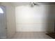 Simple dining area with tile flooring and a ceiling fan at 9163 W Raven Dr, Arizona City, AZ 85123