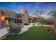 Landscaped backyard with artificial turf and a view of the pool at 9353 N 113Th Way, Scottsdale, AZ 85259