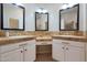 Double vanity bathroom with tile counters and white cabinets at 9353 N 113Th Way, Scottsdale, AZ 85259