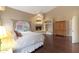 Primary bedroom with fireplace, backyard view, and wood floors at 9353 N 113Th Way, Scottsdale, AZ 85259