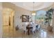 Elegant dining room features a large table, white chairs, and an arched window at 9353 N 113Th Way, Scottsdale, AZ 85259