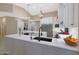 Spacious kitchen with white cabinets, large island, and black sink fixtures at 9353 N 113Th Way, Scottsdale, AZ 85259