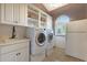 Bright laundry room with washer, dryer, and extra storage at 9353 N 113Th Way, Scottsdale, AZ 85259