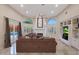 Relaxing living room with brown sectional sofa, fireplace, and built-in shelving at 9353 N 113Th Way, Scottsdale, AZ 85259