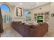 Comfortable living room with brown sectional sofa, fireplace, and built-in shelving at 9353 N 113Th Way, Scottsdale, AZ 85259