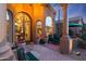 Inviting patio with seating area, lush plants, and a view of the entryway at 9353 N 113Th Way, Scottsdale, AZ 85259