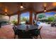Covered patio with outdoor dining area and pool view at 9353 N 113Th Way, Scottsdale, AZ 85259