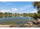 Scenic community lake with lush landscaping and tranquil reflections at 9540 E Spiral Ave, Mesa, AZ 85212