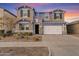 Two-story house with white garage door and landscaping at 9540 E Spiral Ave, Mesa, AZ 85212
