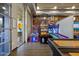 Community game room with arcade games and shuffleboard at 9540 E Spiral Ave, Mesa, AZ 85212