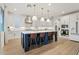 Modern kitchen with white cabinets, blue island, and quartz countertops at 9540 E Spiral Ave, Mesa, AZ 85212
