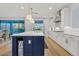 Modern kitchen with white cabinets, blue island, and quartz countertops at 9540 E Spiral Ave, Mesa, AZ 85212