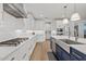 Modern kitchen with white cabinets, blue island, and stainless steel appliances at 9540 E Spiral Ave, Mesa, AZ 85212