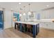 Modern kitchen with white cabinets, blue island, and quartz countertops at 9540 E Spiral Ave, Mesa, AZ 85212