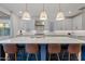 Modern kitchen with white cabinets, blue island, and quartz countertops at 9540 E Spiral Ave, Mesa, AZ 85212
