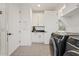 Convenient laundry room with washer, dryer, and ample cabinetry at 9540 E Spiral Ave, Mesa, AZ 85212