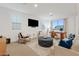 Relaxing living area with comfortable seating and a large TV at 9540 E Spiral Ave, Mesa, AZ 85212