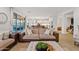 Open living room with hardwood floors, neutral decor, and views to kitchen at 9540 E Spiral Ave, Mesa, AZ 85212