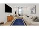 Bright loft area with sectional sofa, large TV, and natural light at 9540 E Spiral Ave, Mesa, AZ 85212