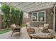 Relaxing patio with pergola, wicker furniture, and lush greenery at 9540 E Spiral Ave, Mesa, AZ 85212