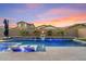 Stunning pool and spa with lounge chairs and fire pit at 9540 E Spiral Ave, Mesa, AZ 85212