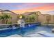 Luxury pool with water features, fire pit, and lounge chairs at 9540 E Spiral Ave, Mesa, AZ 85212