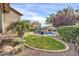 Landscaped backyard with a curved lawn and pool area at 9825 W Desert Elm Ln, Peoria, AZ 85383