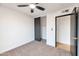 Bedroom with sliding closet doors and ceiling fan at 1015 W Minton Dr, Tempe, AZ 85282