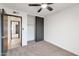 Well-lit bedroom with neutral carpeting and sliding closet doors at 1015 W Minton Dr, Tempe, AZ 85282