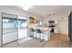 Modern white kitchen with breakfast bar and stainless steel appliances at 1015 W Minton Dr, Tempe, AZ 85282