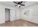 Bedroom with light wood flooring, ceiling fan, and closet at 1031 S 98Th St, Mesa, AZ 85208