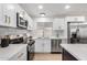 Remodeled kitchen featuring white cabinets, stainless steel appliances, and quartz countertops at 1031 S 98Th St, Mesa, AZ 85208