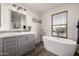 Elegant bathroom with soaking tub and modern vanity at 10617 W Adela Dr, Peoria, AZ 85383