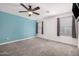 Simple bedroom with blue accent wall and ceiling fan at 10617 W Adela Dr, Peoria, AZ 85383