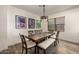 Bright dining area with wood table, bench, and chairs at 10617 W Adela Dr, Peoria, AZ 85383