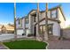 Two-story house with three-car garage, palm trees, and artificial turf at 10617 W Adela Dr, Peoria, AZ 85383