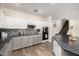 Modern kitchen with gray and white cabinets and granite countertops at 10617 W Adela Dr, Peoria, AZ 85383