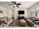 Living room with two sofas, ottoman, and a TV at 10617 W Adela Dr, Peoria, AZ 85383