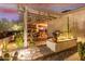 Landscaped backyard with pergola and outdoor kitchen at 1075 W Desert Aster Rd, San Tan Valley, AZ 85143