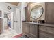 Elegant bathroom with a large vanity, walk-in closet, and modern fixtures at 1075 W Desert Aster Rd, San Tan Valley, AZ 85143