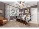 Well-lit bedroom with a double bed, wicker chair, and window with plantation shutters at 1075 W Desert Aster Rd, San Tan Valley, AZ 85143