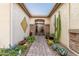 Courtyard entry with gated access, cactus plants, and brick pavers creates an inviting entrance at 1075 W Desert Aster Rd, San Tan Valley, AZ 85143