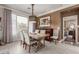 Bright dining room with a large table, six chairs, and a view into a bedroom at 1075 W Desert Aster Rd, San Tan Valley, AZ 85143