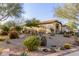 Landscaped yard with drought-tolerant plants and rock features at 1075 W Desert Aster Rd, San Tan Valley, AZ 85143