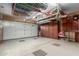 Spacious garage with overhead storage and custom wood cabinets at 1075 W Desert Aster Rd, San Tan Valley, AZ 85143